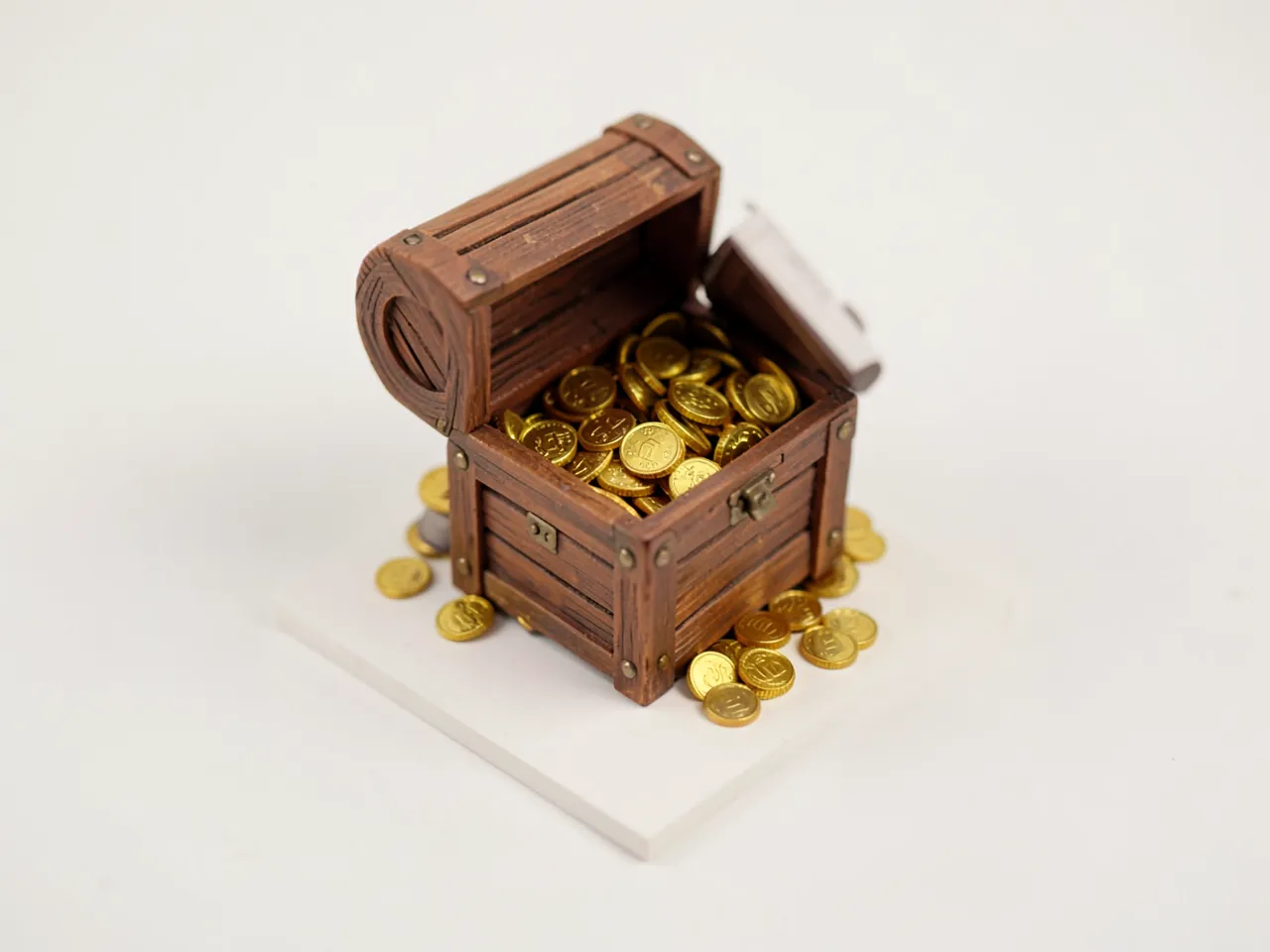 Isometric diorama style: a treasure chest full of gold coins